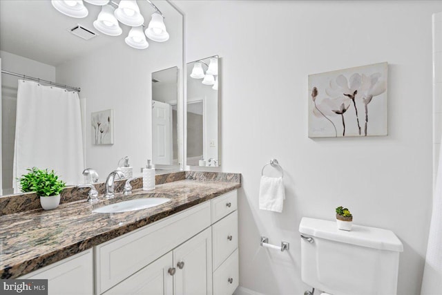 bathroom featuring vanity and toilet