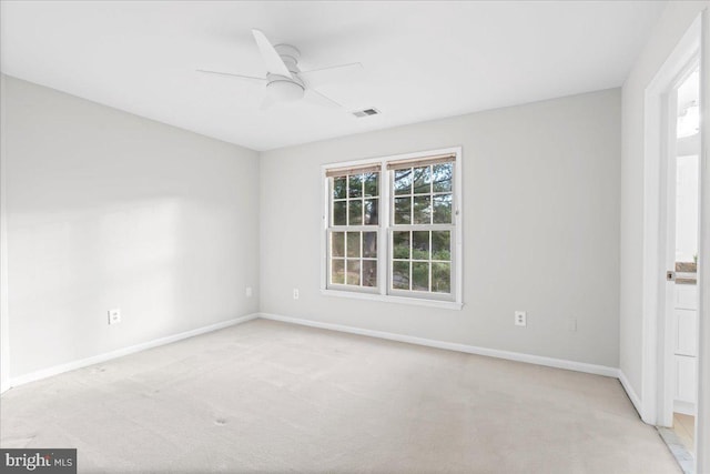 carpeted spare room with ceiling fan