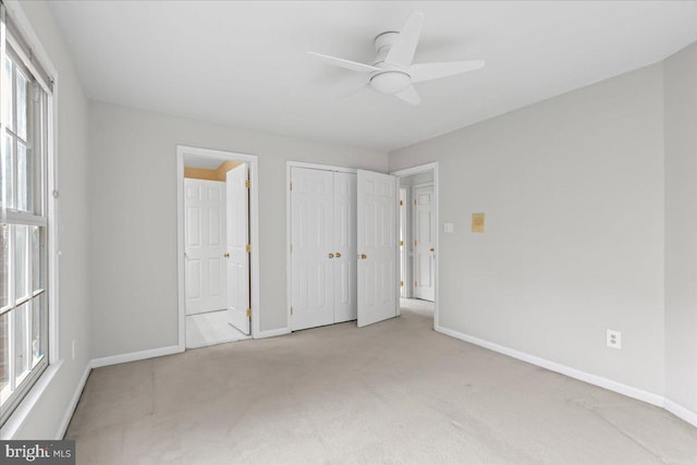 unfurnished bedroom with ceiling fan and light carpet