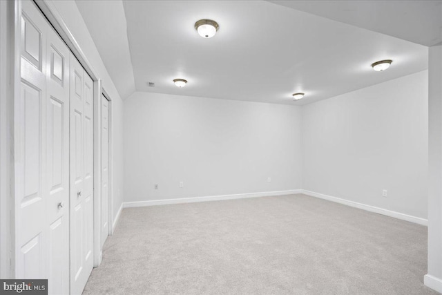 basement featuring light colored carpet