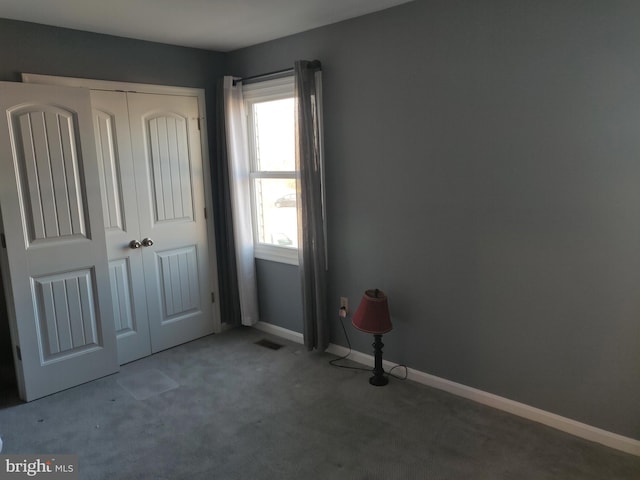 unfurnished bedroom featuring a closet and carpet floors