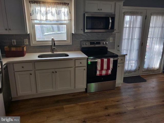 kitchen featuring sink, white cabinets, stainless steel appliances, and dark hardwood / wood-style floors