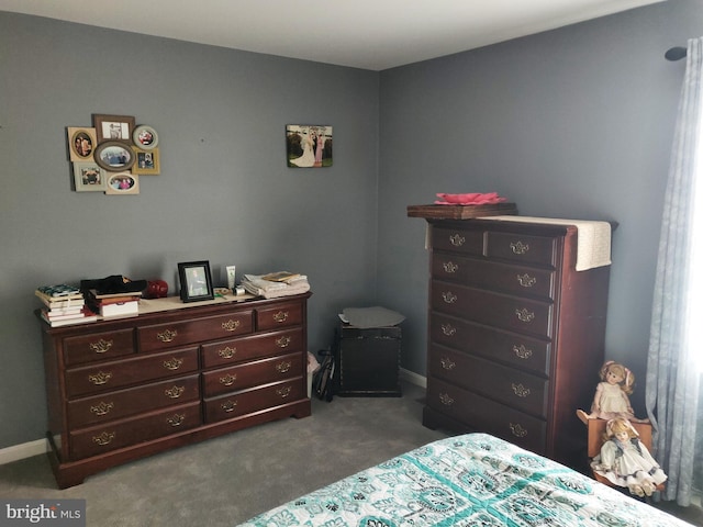 bedroom featuring dark carpet