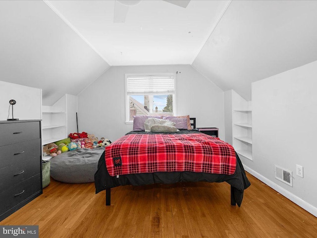 bedroom featuring hardwood / wood-style floors, ceiling fan, and lofted ceiling