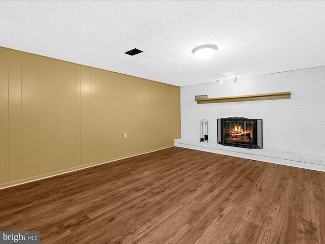 unfurnished living room with a fireplace and hardwood / wood-style floors