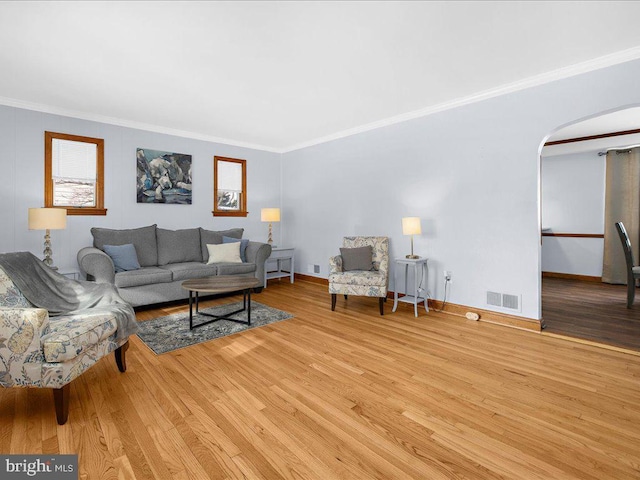 living room featuring light hardwood / wood-style flooring and ornamental molding