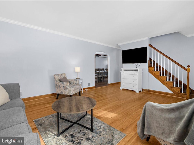 living room featuring hardwood / wood-style flooring and ornamental molding