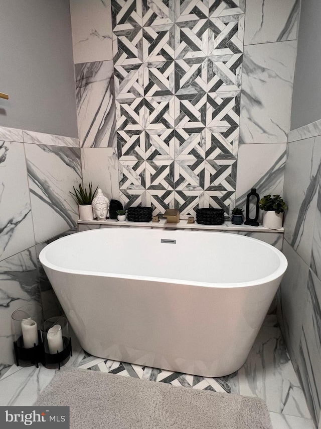 bathroom featuring a bath and tile walls