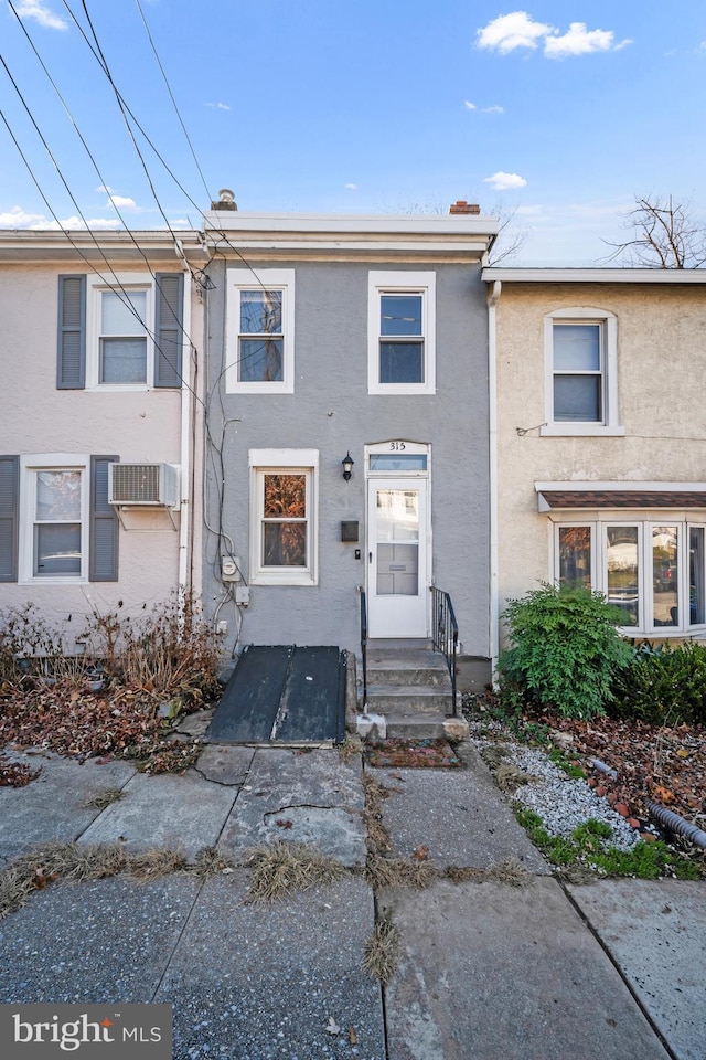 townhome / multi-family property featuring a wall mounted air conditioner