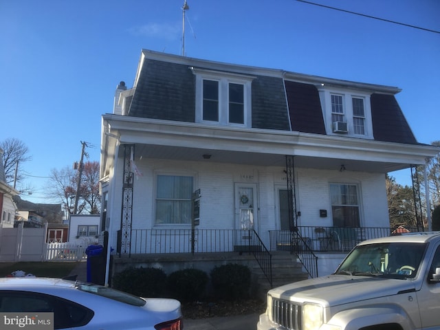 view of front facade with a porch and cooling unit