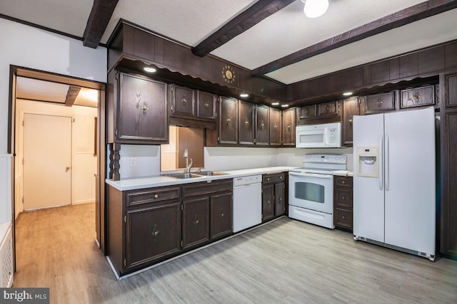 kitchen with white appliances, sink, light wood-type flooring, dark brown cabinets, and beam ceiling