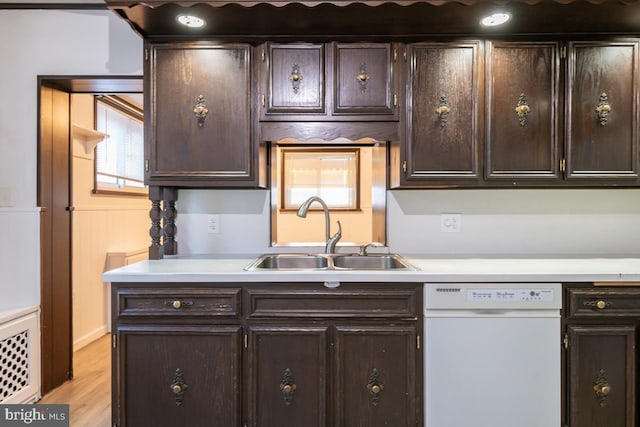 kitchen featuring dishwasher, light hardwood / wood-style floors, dark brown cabinets, and sink