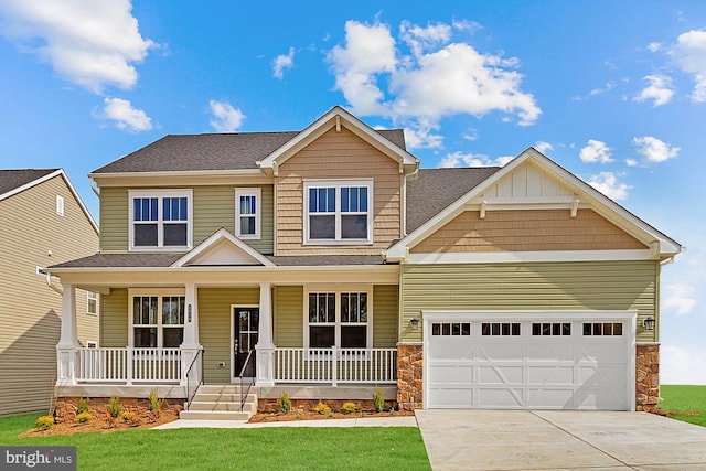 craftsman-style home featuring a porch, a garage, and a front lawn