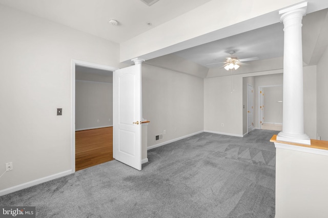 spare room featuring ornate columns, visible vents, baseboards, carpet flooring, and ceiling fan