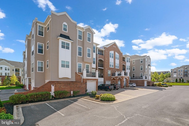view of property featuring uncovered parking and a residential view