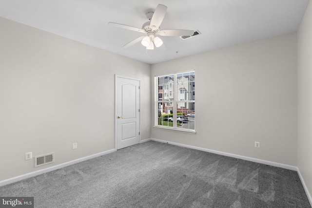 carpeted empty room featuring baseboards and visible vents
