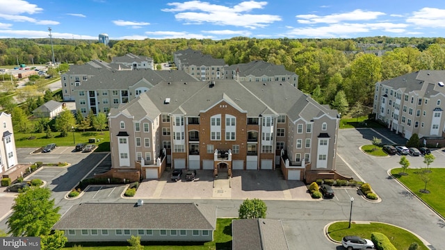 birds eye view of property featuring a wooded view
