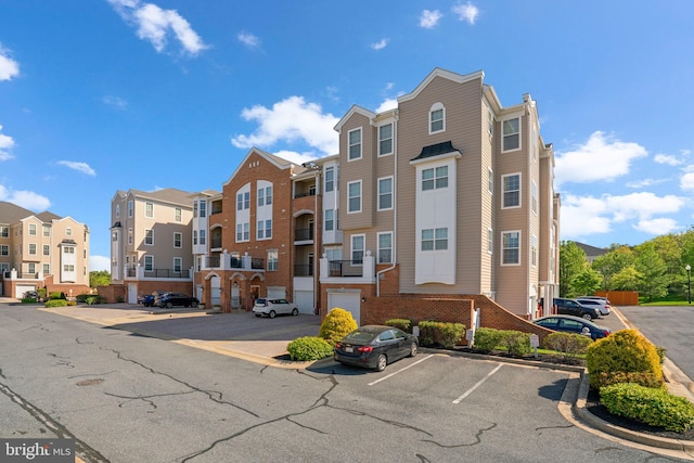 view of building exterior featuring uncovered parking and a residential view