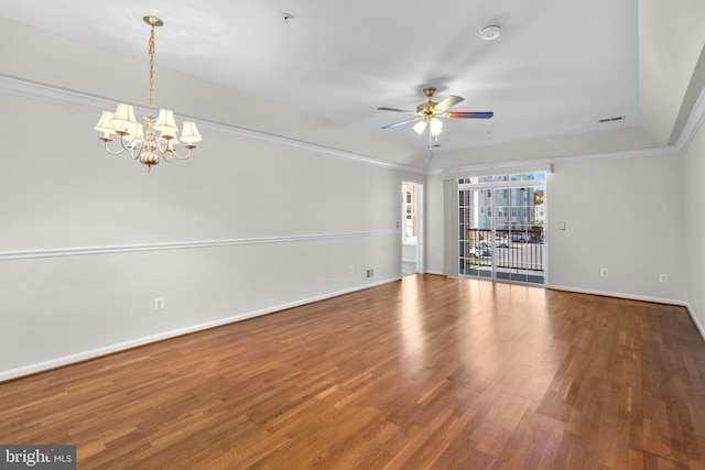 unfurnished room with ceiling fan with notable chandelier, wood finished floors, baseboards, and crown molding