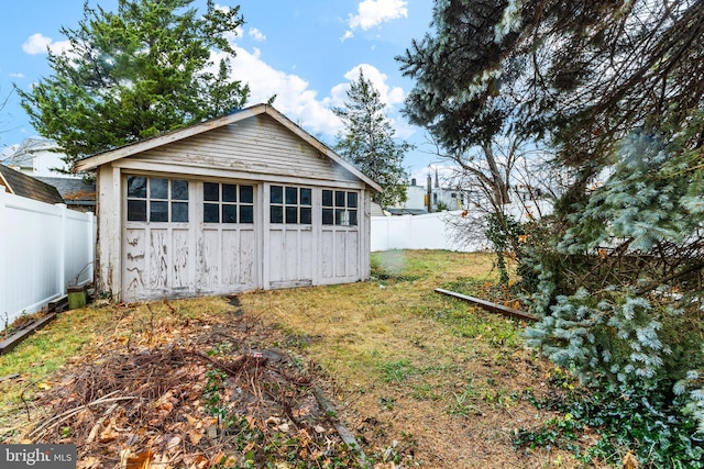 rear view of property featuring a yard and a shed