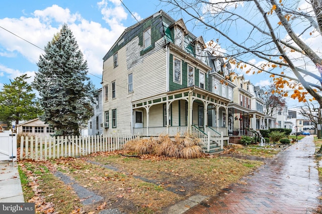 view of side of property with covered porch