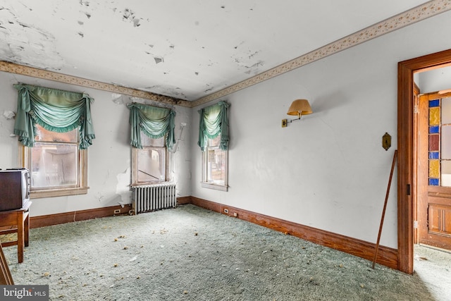 unfurnished room featuring carpet floors and radiator