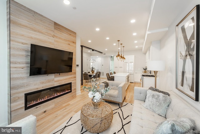 living room with light hardwood / wood-style floors and a fireplace