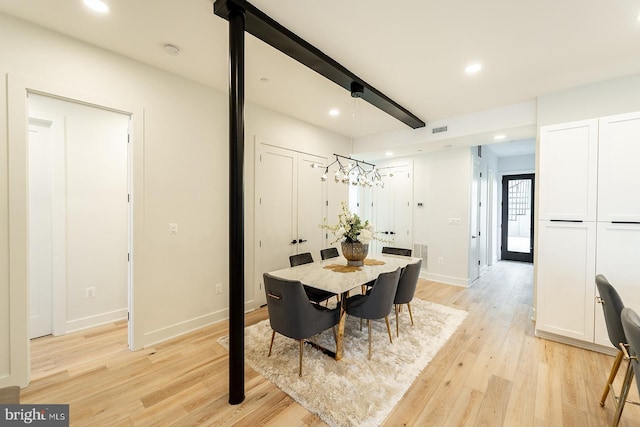 dining space with a chandelier and light hardwood / wood-style flooring