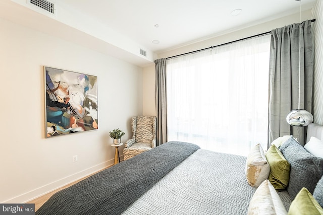 bedroom with hardwood / wood-style floors