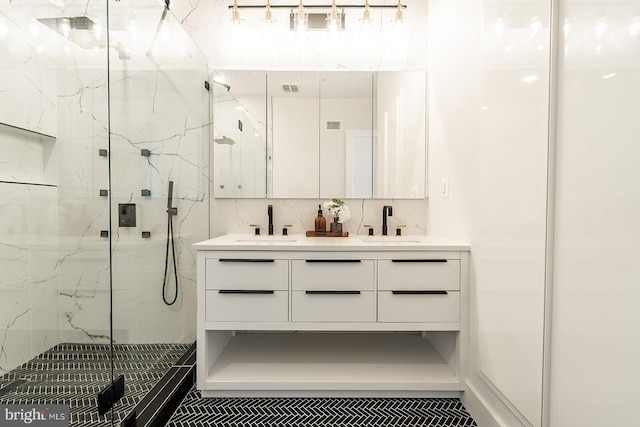 bathroom with vanity, a shower with shower door, and tasteful backsplash