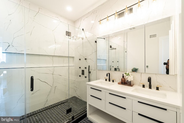 bathroom with vanity, backsplash, and an enclosed shower