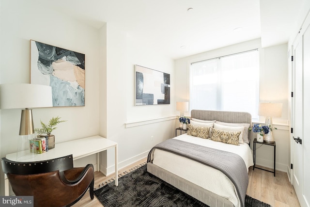 bedroom with hardwood / wood-style flooring