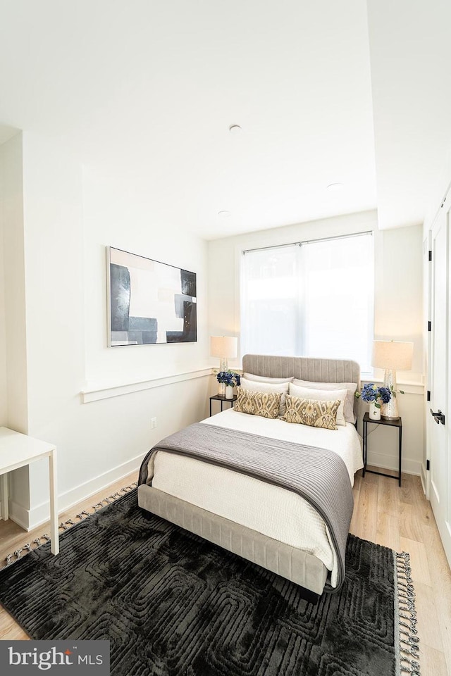 bedroom with hardwood / wood-style floors