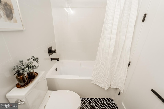 bathroom featuring shower / bath combination with curtain and toilet