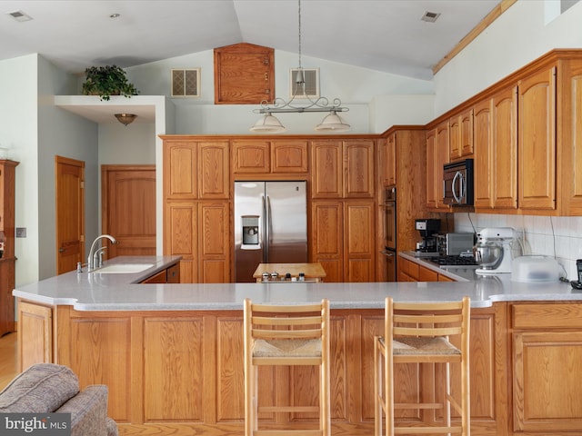 kitchen featuring decorative backsplash, stainless steel appliances, lofted ceiling, and sink