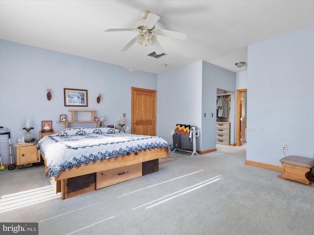 carpeted bedroom with ceiling fan and a closet