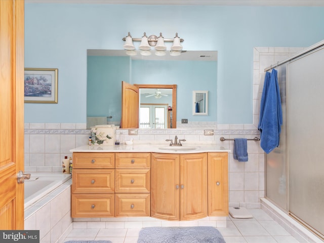 bathroom featuring tile patterned flooring, vanity, ceiling fan, and independent shower and bath