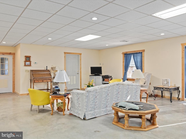 living room with a drop ceiling