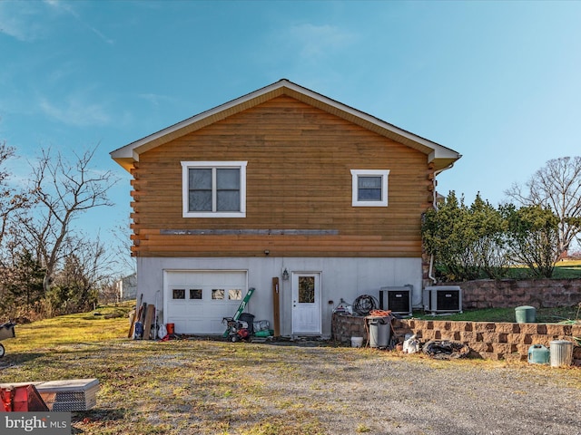 view of front of house featuring central air condition unit and a garage