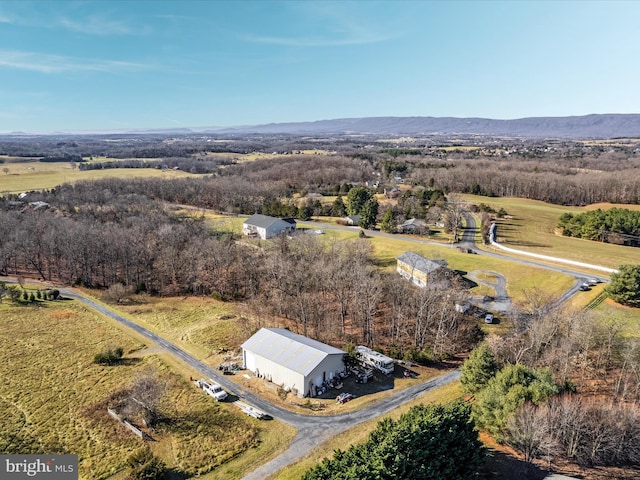 drone / aerial view featuring a mountain view and a rural view