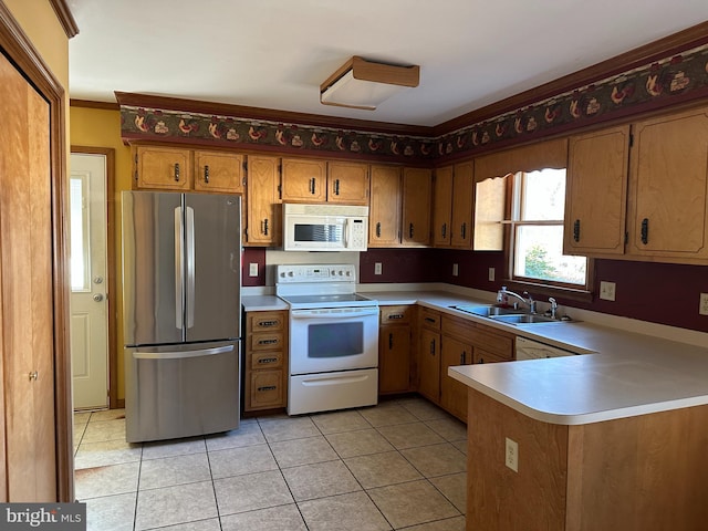 kitchen featuring sink, kitchen peninsula, crown molding, white appliances, and light tile patterned floors