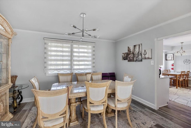 dining room featuring a chandelier, ornamental molding, and dark wood-type flooring