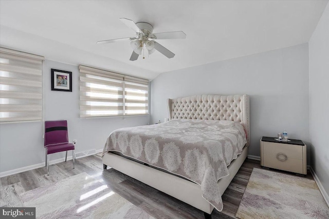 bedroom featuring wood-type flooring, vaulted ceiling, and ceiling fan