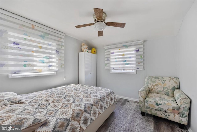 bedroom with ceiling fan, dark hardwood / wood-style floors, and lofted ceiling