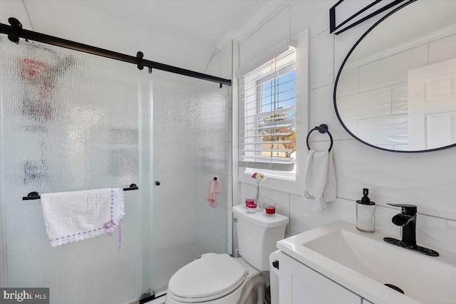 bathroom featuring an enclosed shower, vanity, and toilet