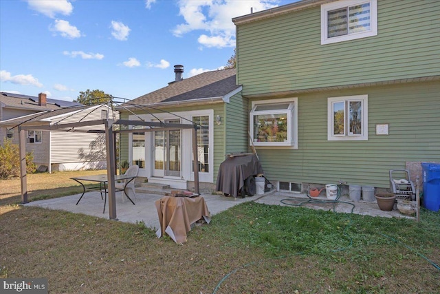 rear view of house with a lawn and a patio