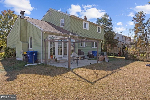 back of house with a yard, a patio, and central AC