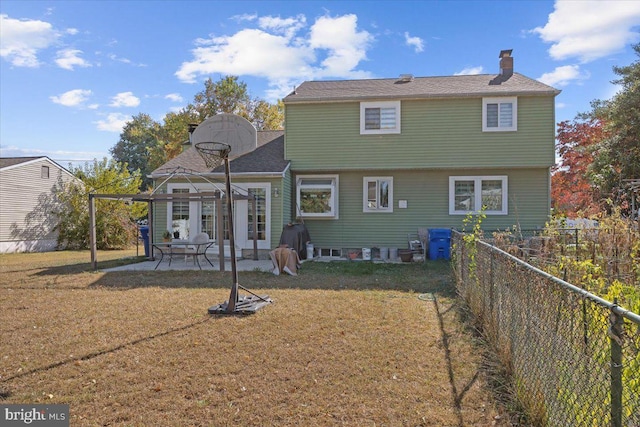 back of property with a patio area and a lawn