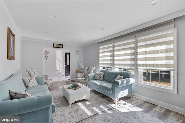 living room featuring wood-type flooring and ornamental molding