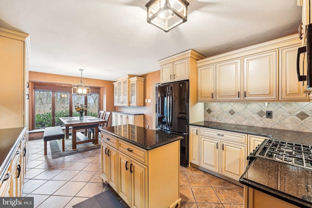 kitchen with a center island, black appliances, decorative backsplash, light tile patterned floors, and decorative light fixtures